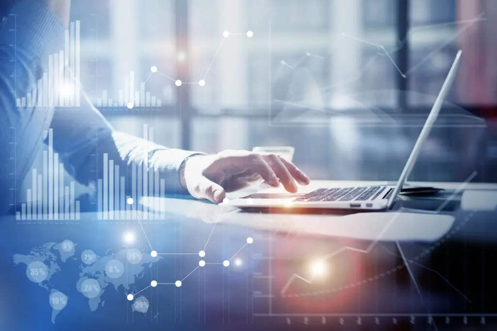 A gaphic of a fundraising professional conducting prospect research on their laptop with data visualizations superimposed.