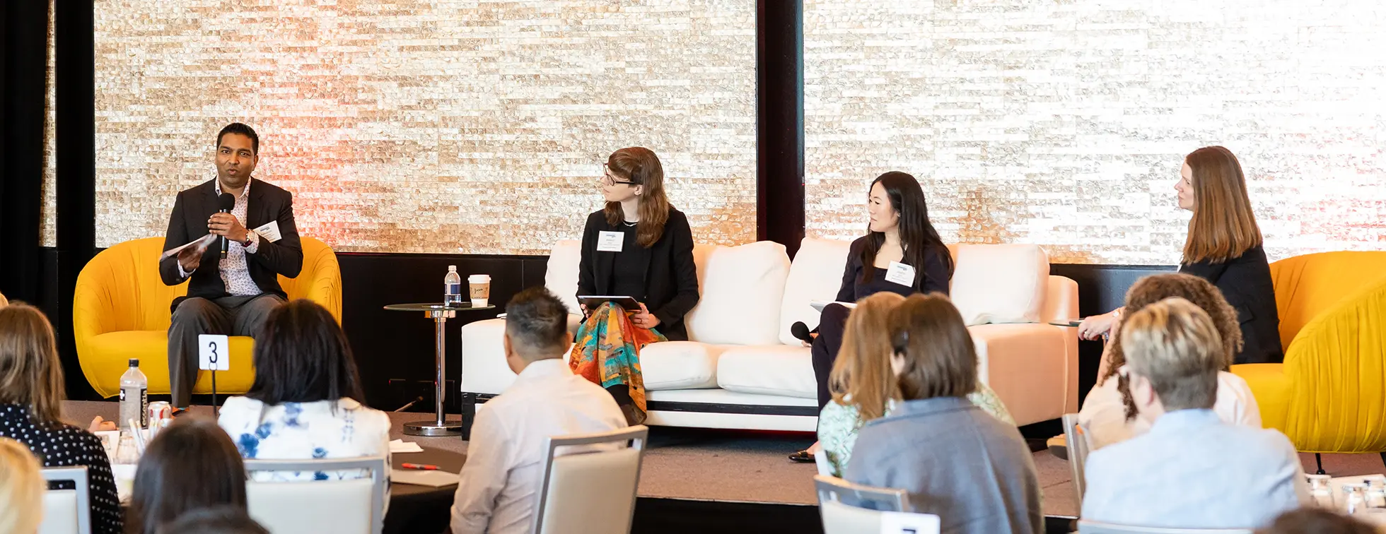 A picture of several CCS Fundraising expert consultants sharing their insights on a stage in a large room.