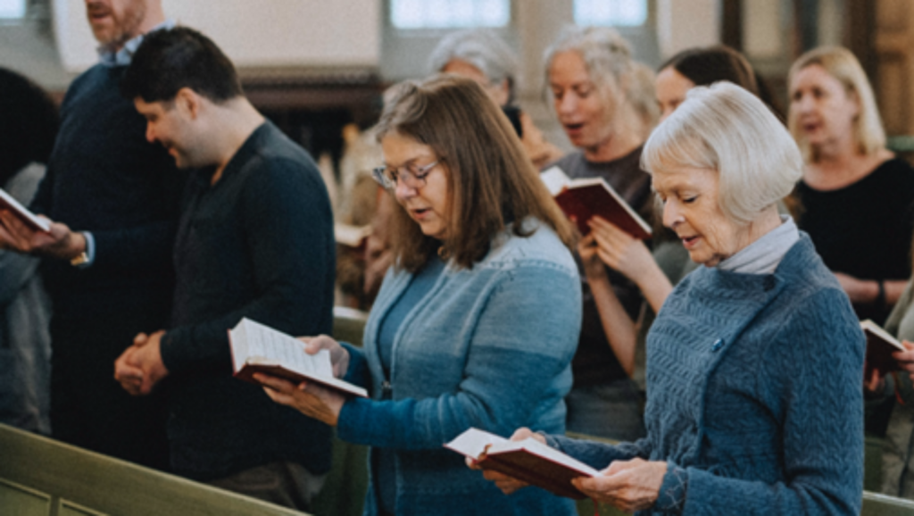 A picture of members of a Catholic Diocese standing in the pews.