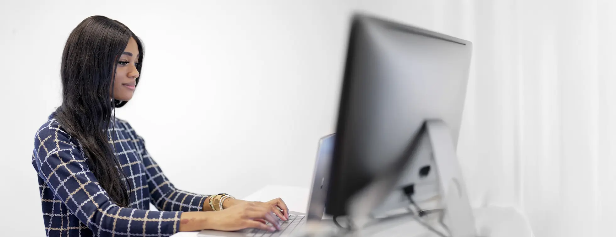 A picture of someone finding information on their computer to contact CCS Fundraising.