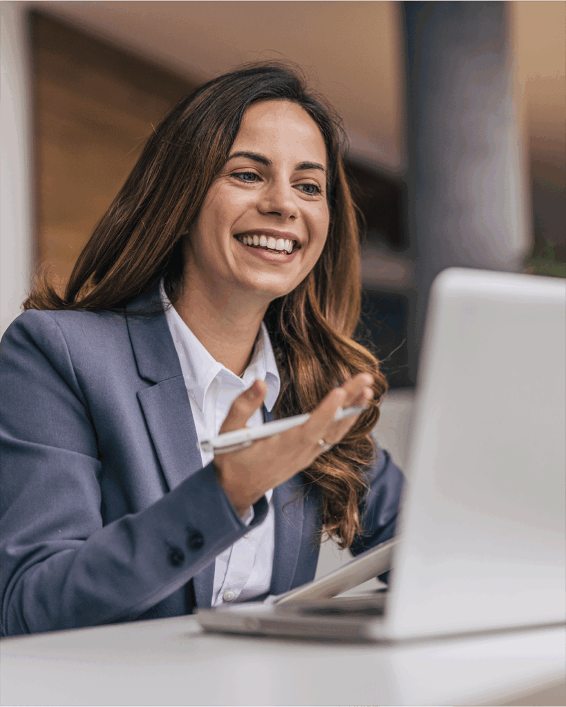 A picture of a nonprofit professional watching the Perspectives on Philanthropy | Giving USA 2025 webinar on their laptop while holding a pen in one hand.