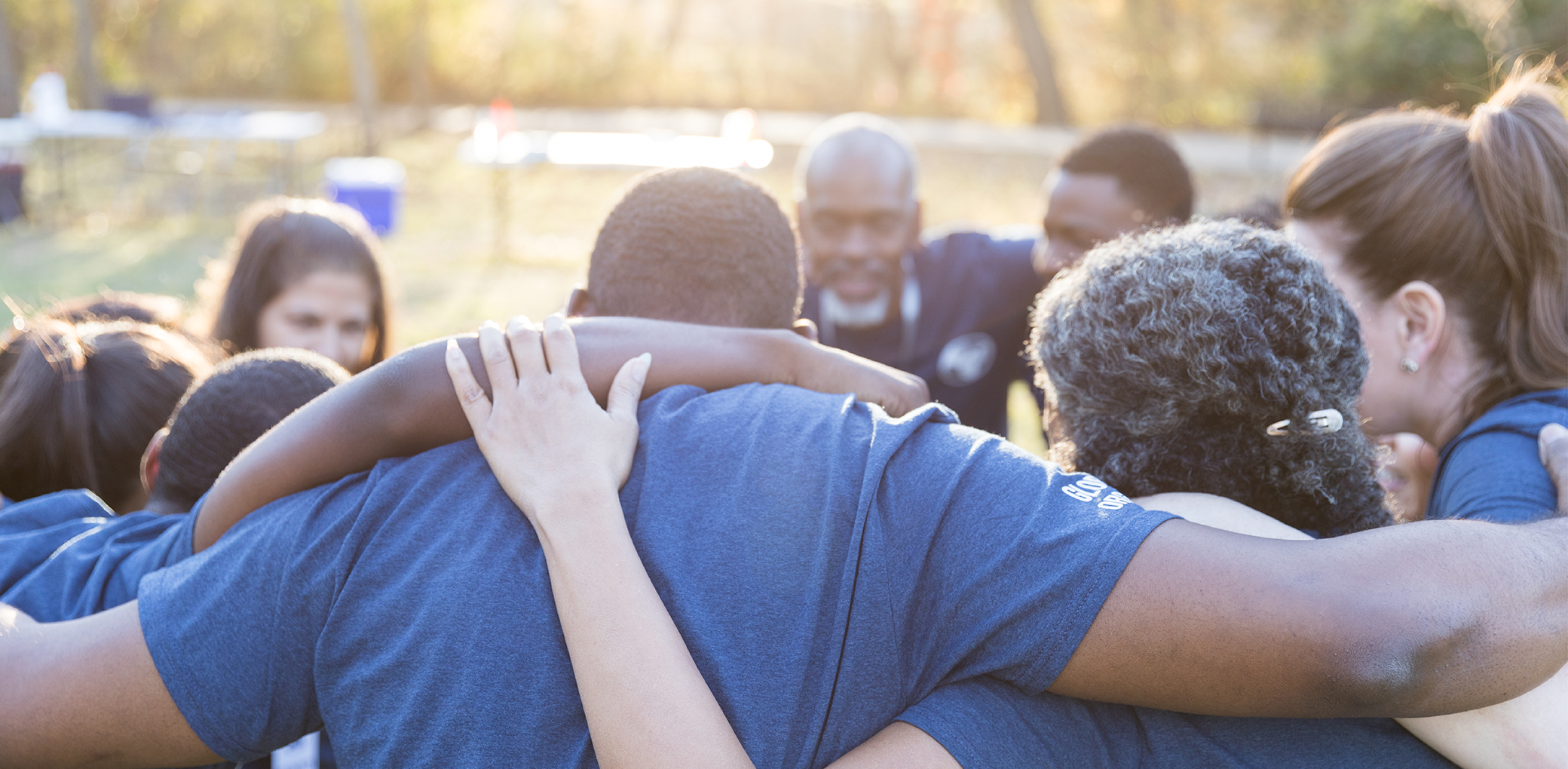 A picture of a group of human service volunteers huddling together.