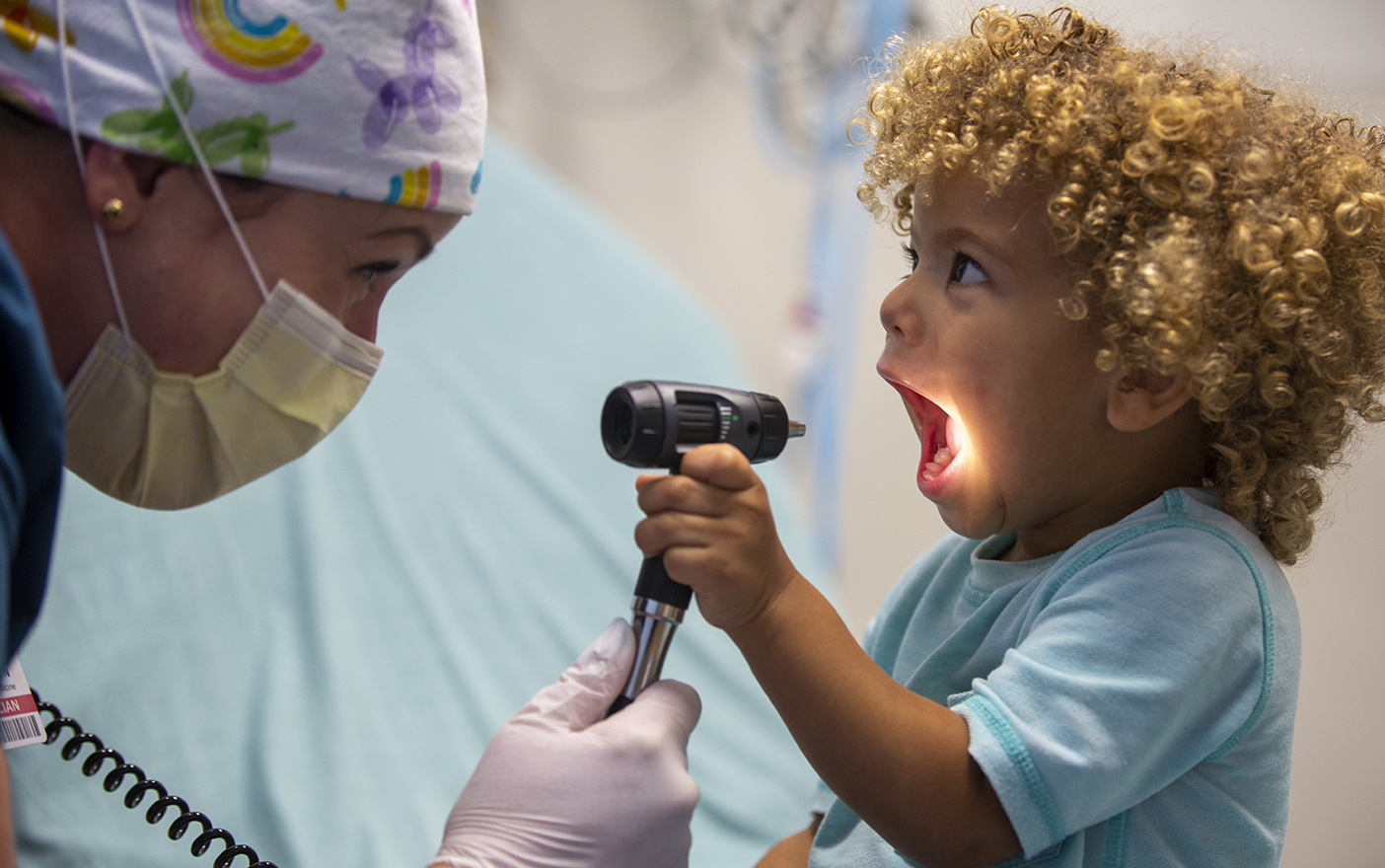 Toddler boy in ED with light scope doctor