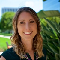 Woman smiling at camera in headshot.