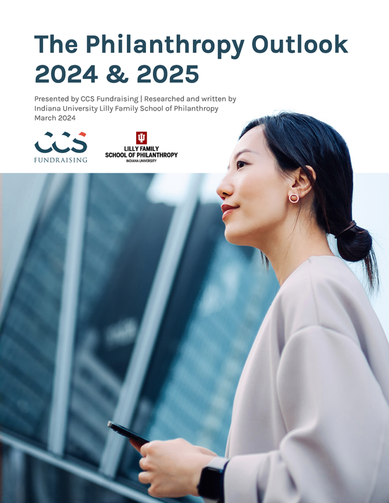 The cover page of The Philanthropy Outlook 2024 & 2025, which includes an image of person looking confidently ahead in an urban landscape.