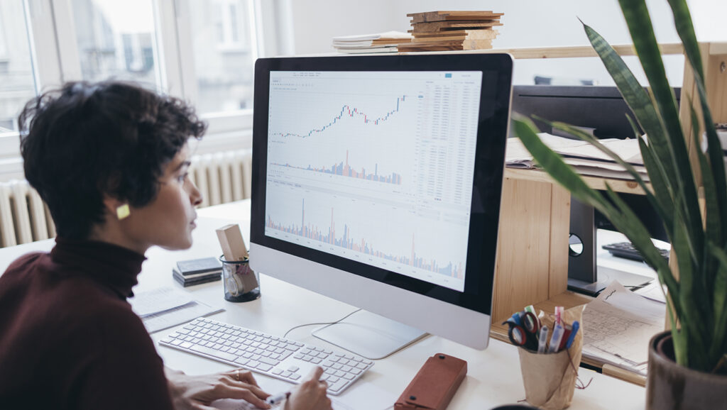 A picture of a major gift officer reviewing predictive modeling data on donor prospects.